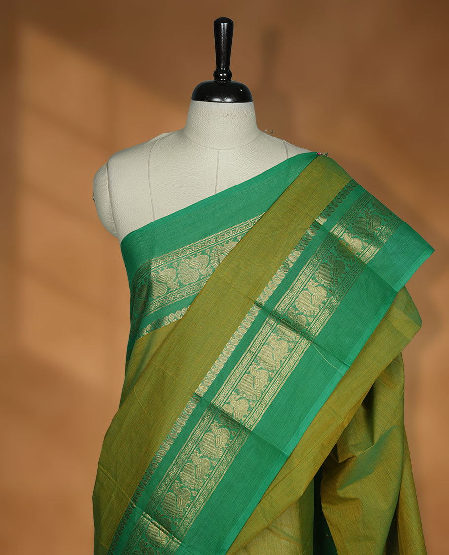 Lemon colour chettinad cotton saree featuring plain body, contrast Green colour with traditional gold zari border paired with matching blouse.