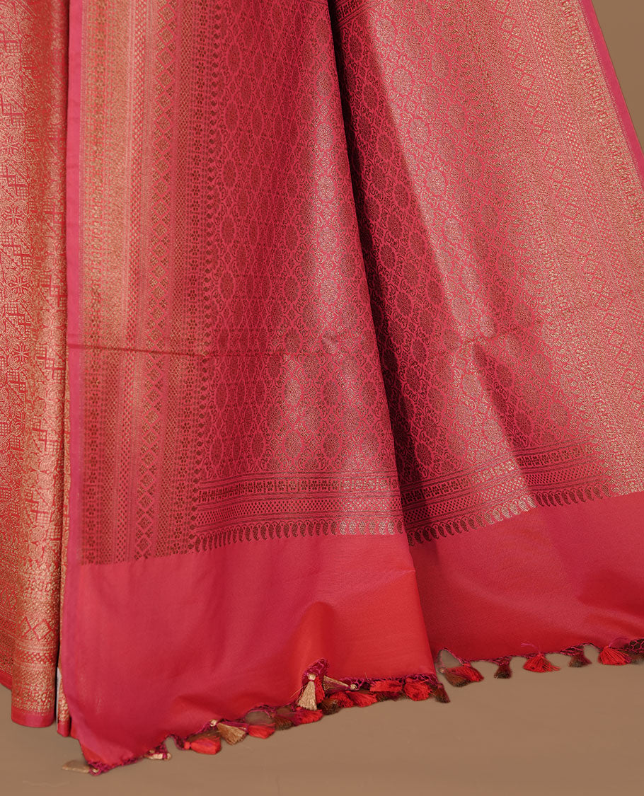 Rani pink colour semi banaras katan saree featuring Gold zari Pattern across body, complemented by self colour with zari border, paired with matching blouse piece.