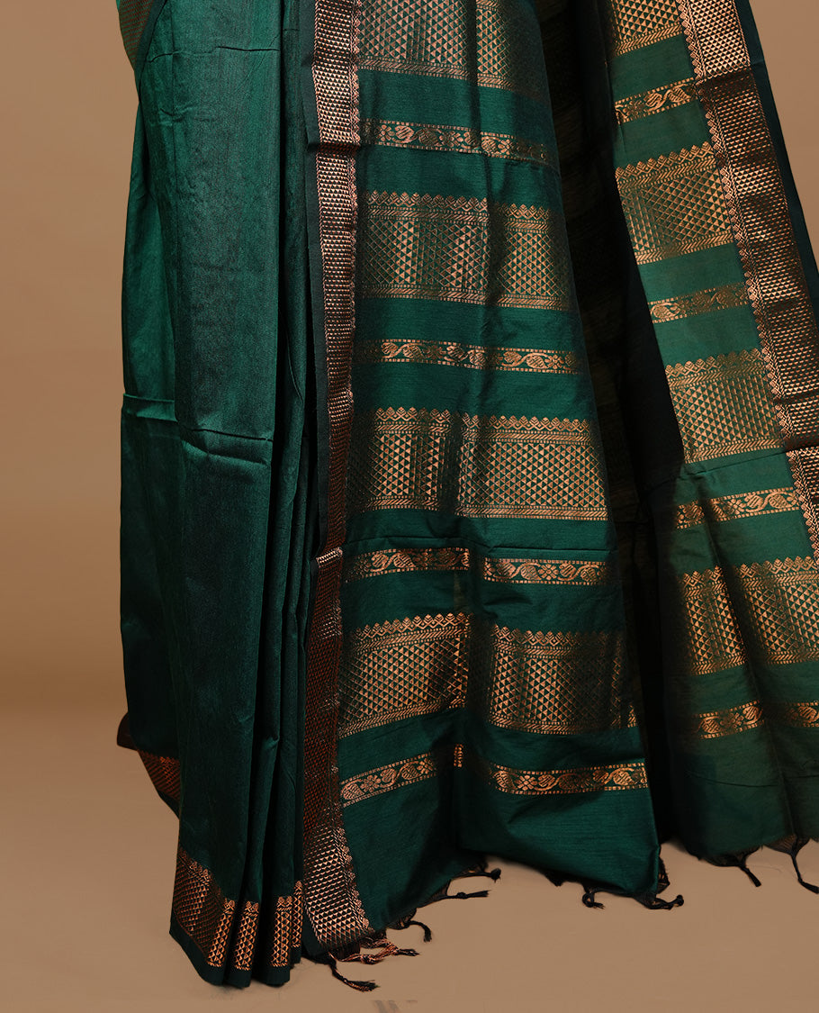 Green colour kalyani cotton saree featuring gold zari motifs on body, highlighting self colour with Antique gold zari border, paired with matching blouse piece.