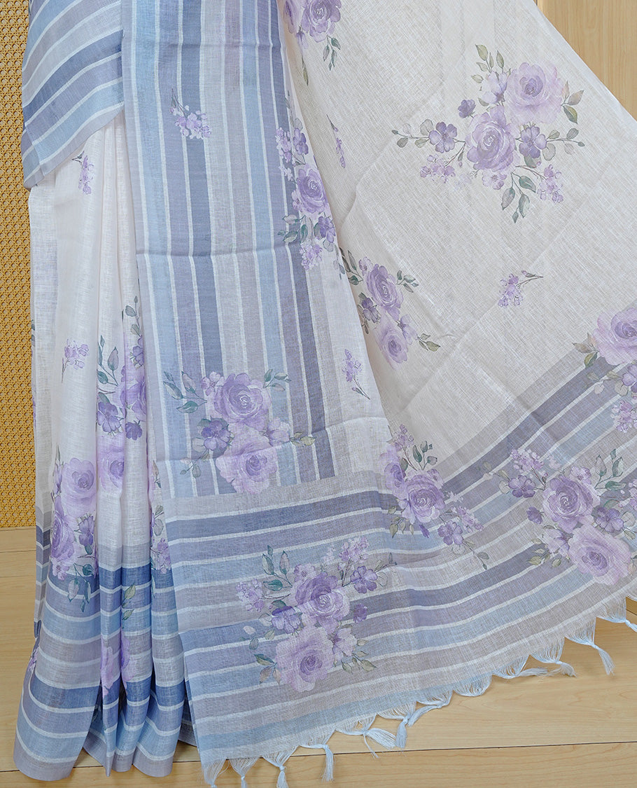Cream colour semi linen saree featuring Purple colour floral print on body, complemented by contrast Strip pattern border, comes with matching blouse piece.