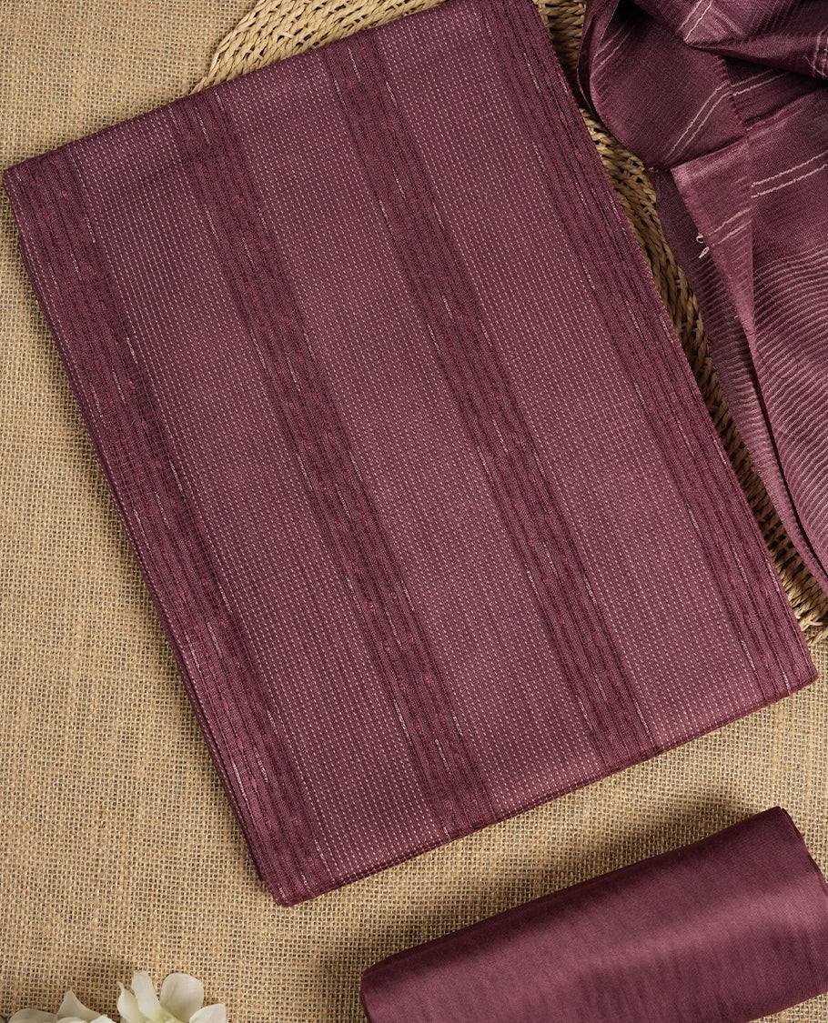 Dark mauve colour tussar suit material with elegant woven stripes & Comes with a matching dupatta adorned with tassels and a plain bottom.