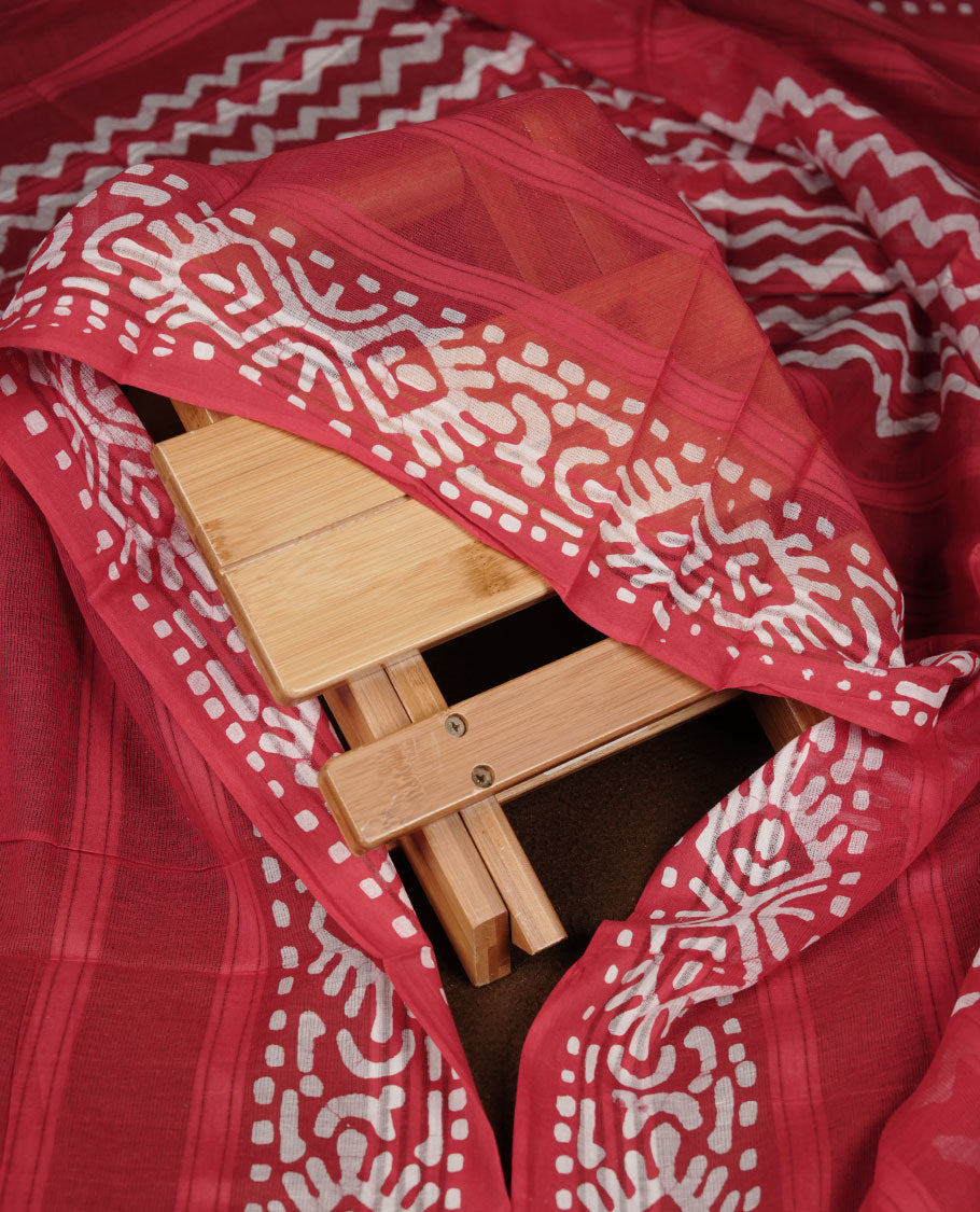 Red colour churidar material featuring white floral printed body, paired with a matching chevron printed dupatta.