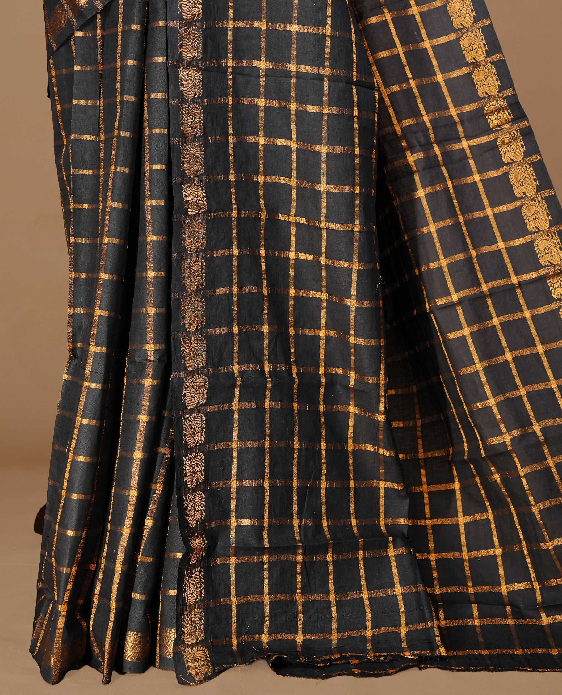 Black colour Sungudi cotton saree Featuring gold Zari check on body, complemented by gold zari peacock motif on self colour border, paired with matching blouse piece.