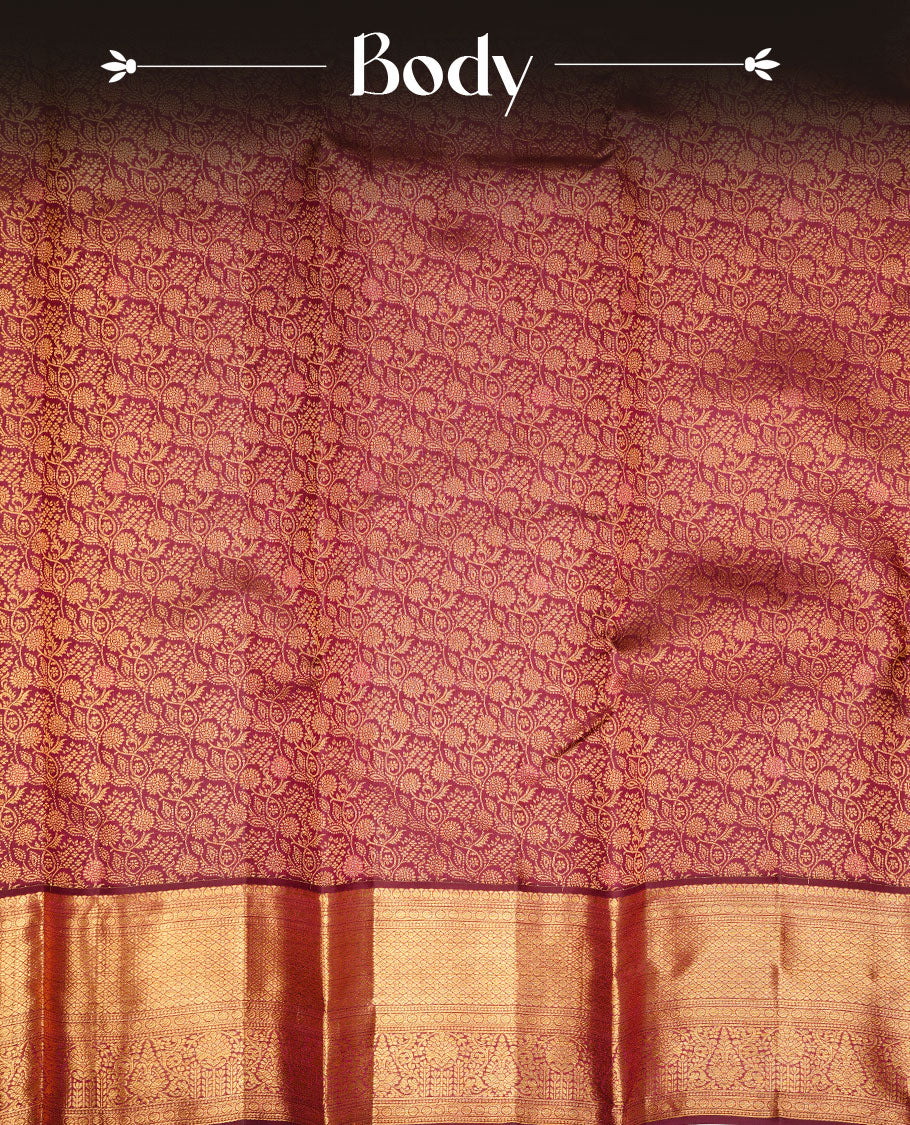 Burgundy colour kancheepuram silk saree featuring gold zari pattern across body, complemented by selfcolour border traditional zari border, paired with matching blouse piece.