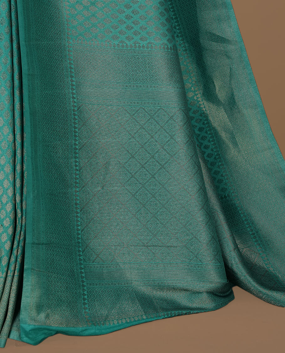 Aqua colour Semi Banaras Katan saree featuring Antique zari motifs on across body, complemented by self colour zari border, paired with matching blouse piece.