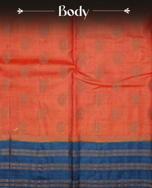 Rust orange colour pure tussar Banaras silk saree featuring elegant gold zari motifs across the body, complemented by a contrast teal border with rich zari detailing. Comes with a matching blouse piece