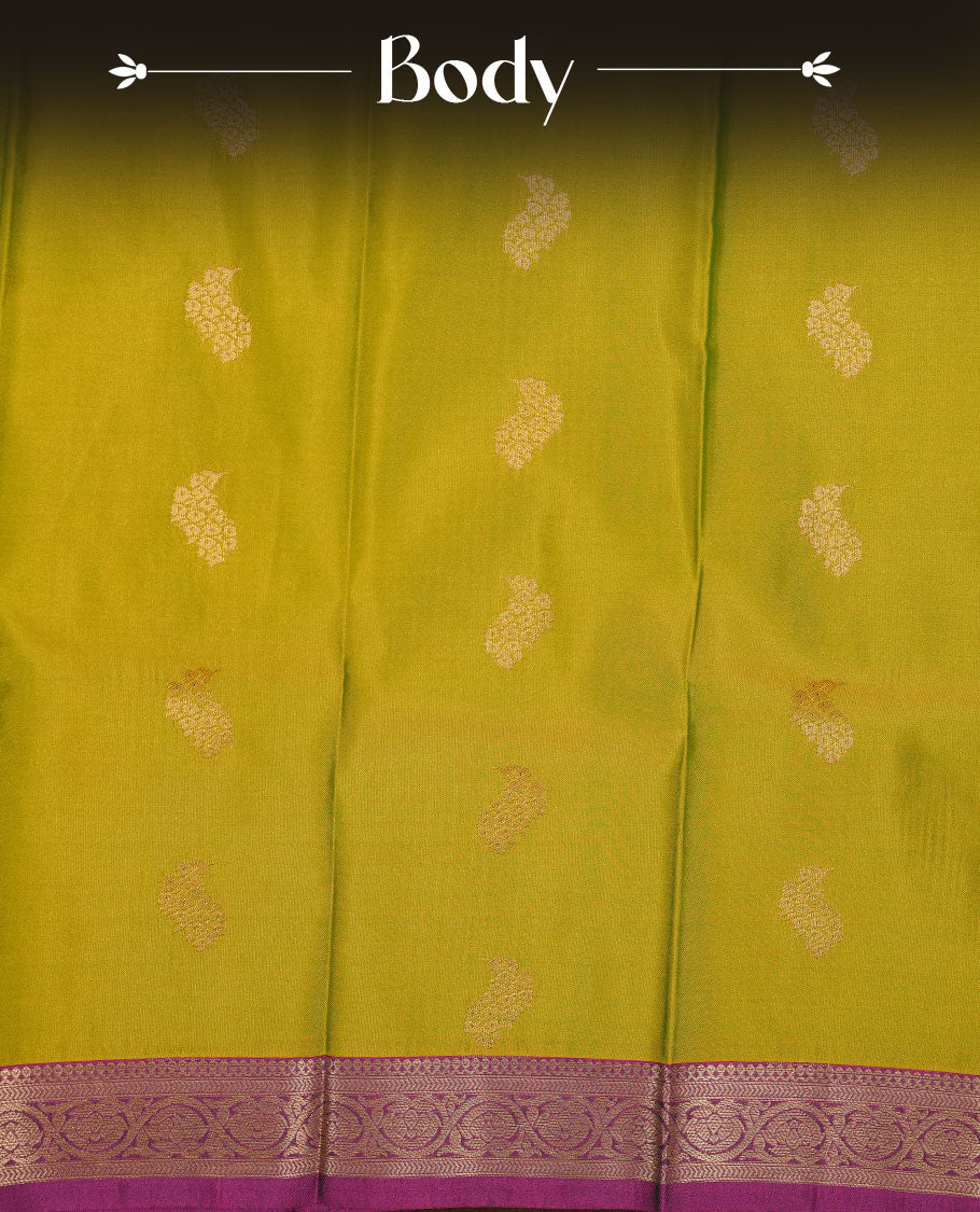 Lemon green colour soft silk saree featuring Gold zari motifs on body, complemented by contrast purple colour with traditional border, paired with matching blouse piece.