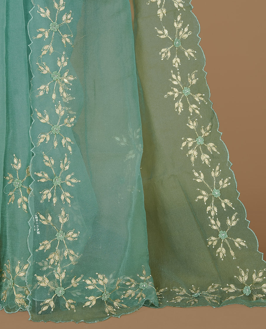 Pastel green colour crush organza saree featuring gold thread floral and stone worked body, highlighting scalp designed border, paired with matching blouse piece.