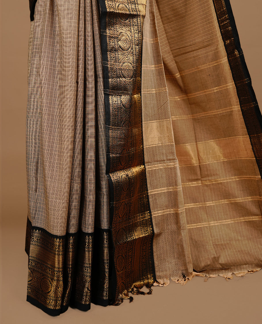 Cream tan colour chettinad cotton saree featuring gold zari motifs on body, complemented by Black colour with zari border, paired with matching blouse piece.