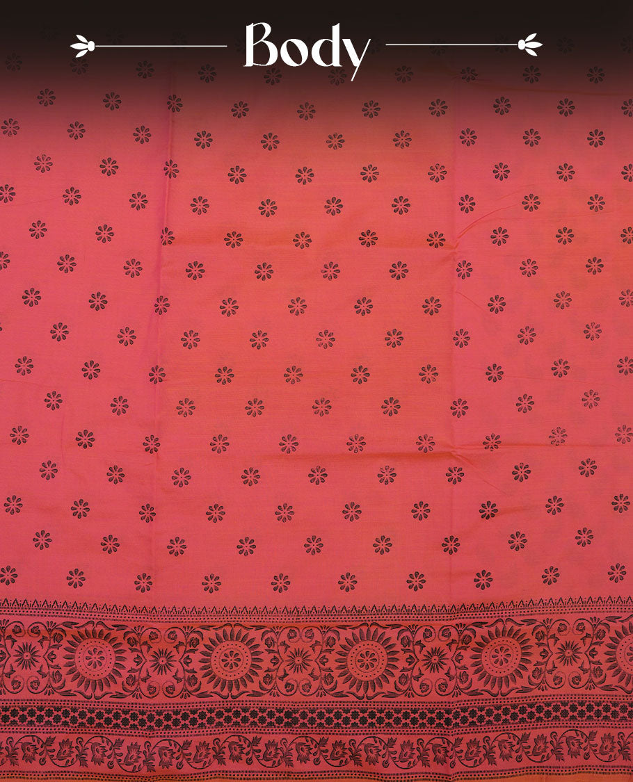 Peach Orange colour poly cotton saree with black floral butti motifs on the body, paired with a matching pallu featuring black ornate floral jaal and stripes on the border, and a coordinated all‑over black paisley printed blouse piece.