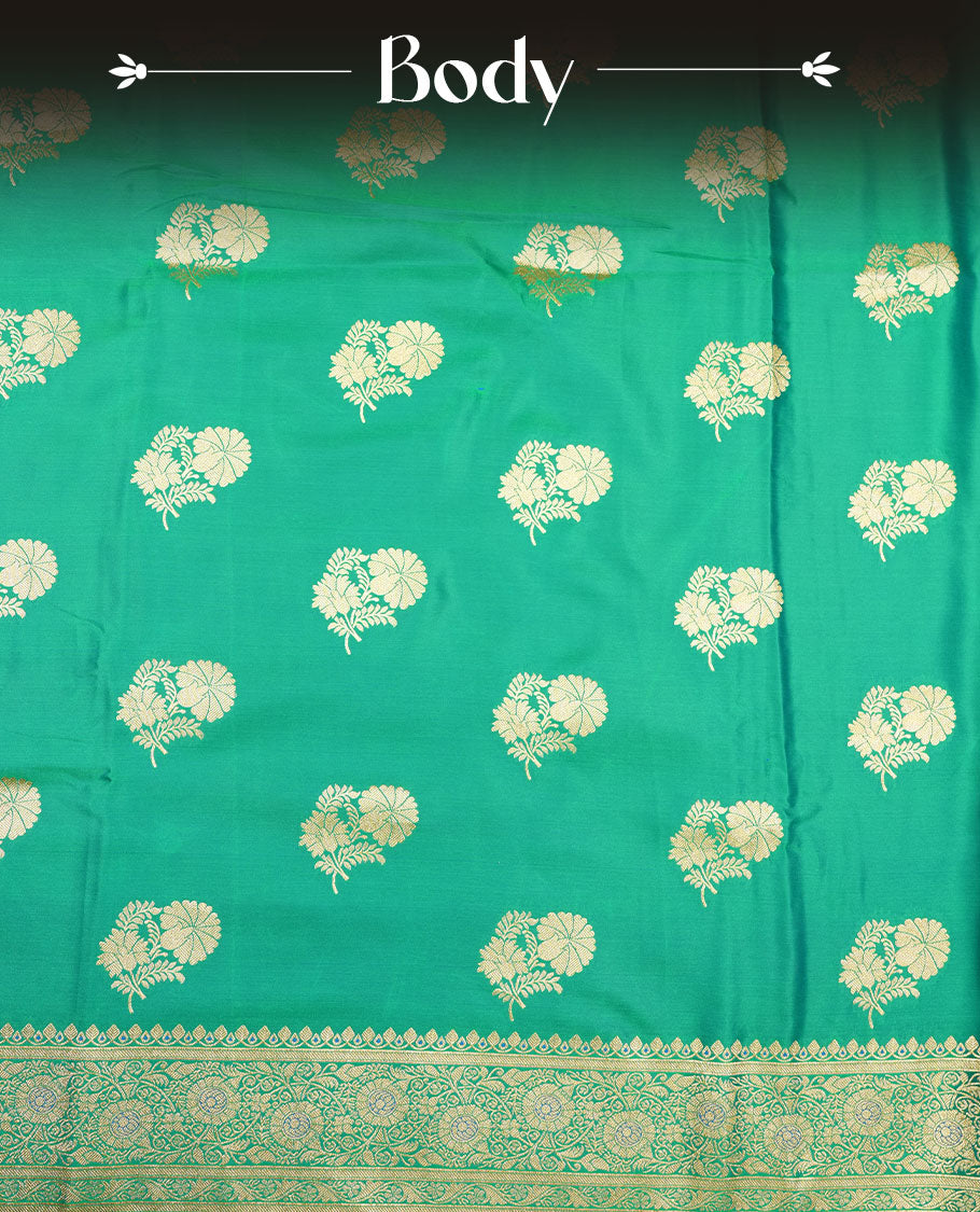 Emerald green colour Banaras Satin Crepe saree featuring gold zari floral motifs on the body, a richly woven traditional border with intricate gold zari detailing, and paired with a matching blouse.