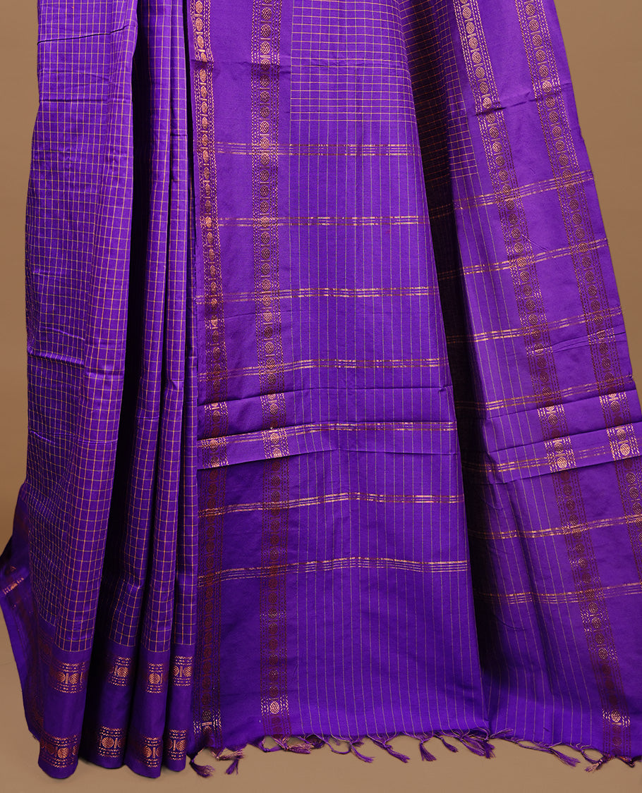 Indigo colour kalyani cotton saree featuring check pattern on body, highlighting self colour with simple gold zari border, paired with matching blouse piece.