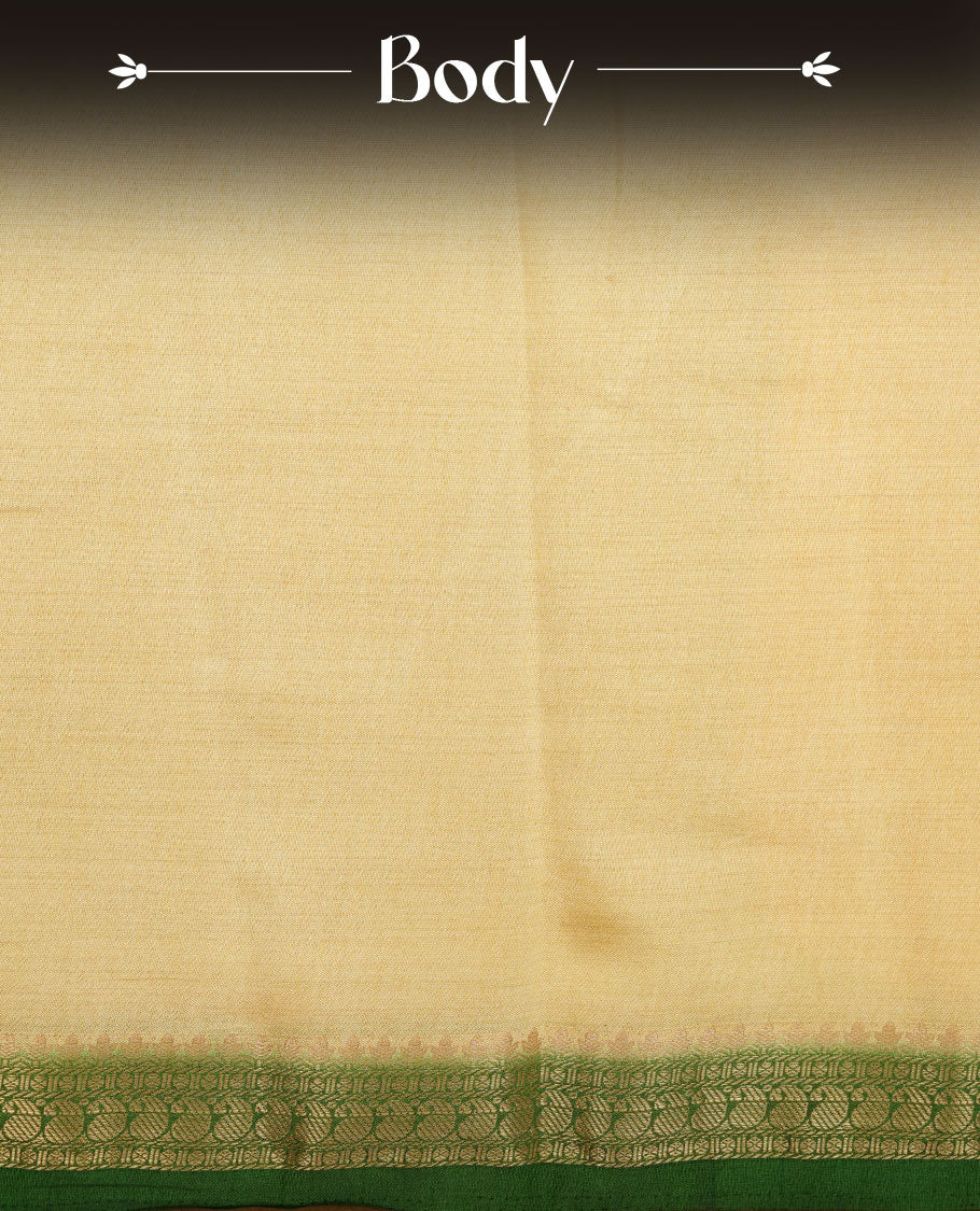 Cream colour tussar saree featuring elegant plain body, contrast Green colour gold zari border and comes with matching blouse piece.