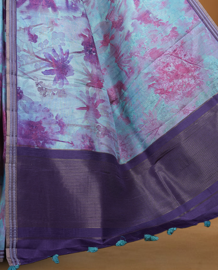 Aqua green colour semi tussar silk saree featuring an abstract digital floral printed body with a rich purple self border and tasselled pallu, paired with a matching blouse.