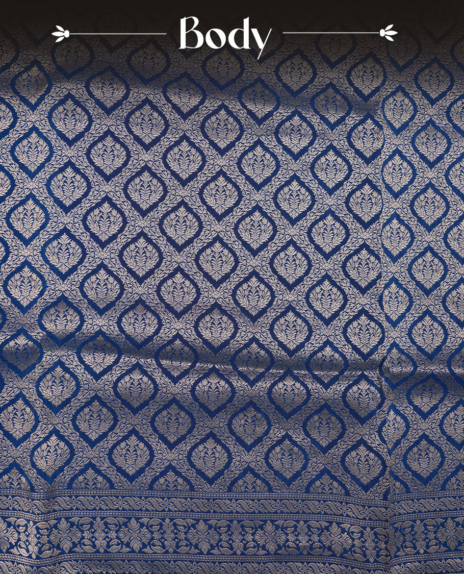 Dark blue colour banaras satin crepe saree featuring gold zari pattern across body, with self colour border with gold zari pattern and paired with matching blouse.