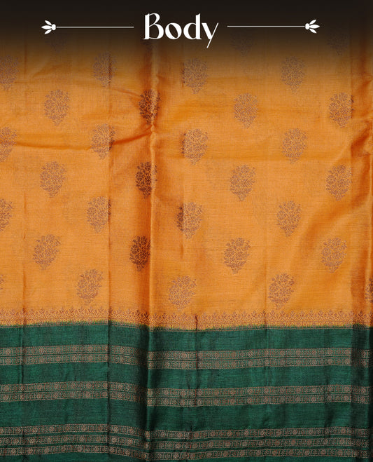 Mustard colour pure tussar banaras silk saree featuring gold zari motifs on body, highlighting contrast green colour with zari border, paired with matching blouse piece.