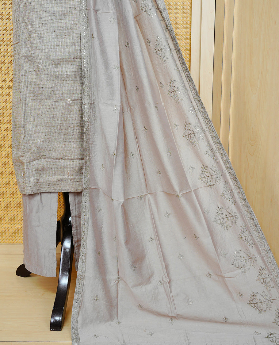 Tan Beige colour Tissue Churidar Set featuring delicate embroidery and subtle bead detailing on the yoke, paired with matching solid pants and dupatta.