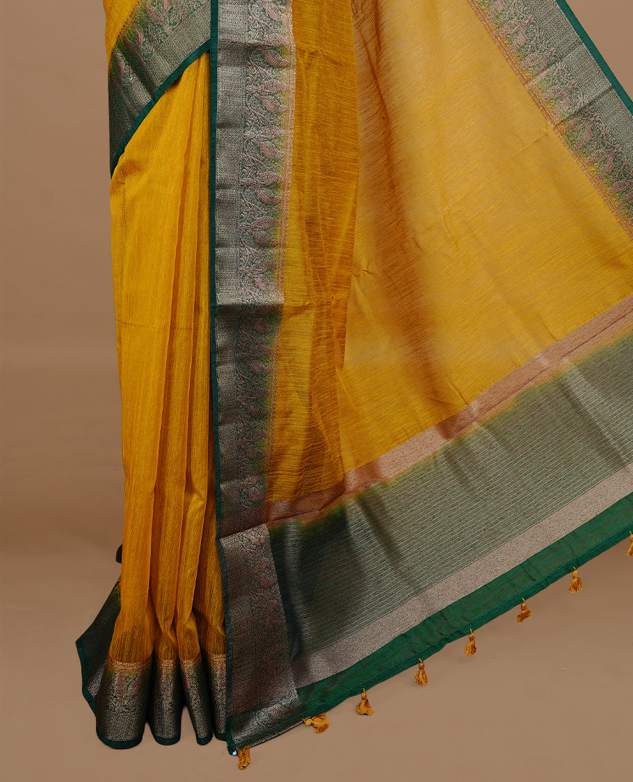 Yellow colour Semi linen saree featuring Elegant plain body, complemented by contrast Green colour With Antique zari border, paired with matching blouse piece.