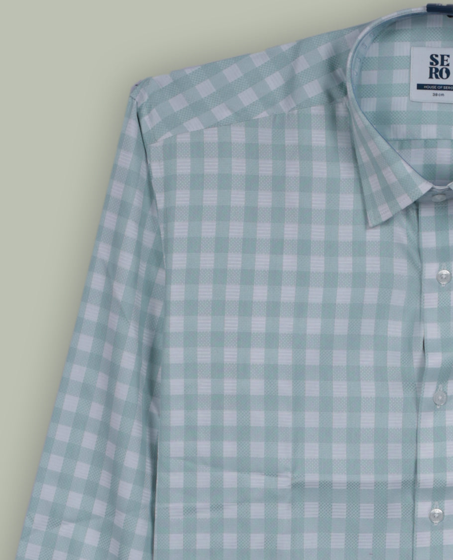 Mint green and white checkered long sleeve shirt made from lightweight cotton fabric & Features a classic collar, front button closure, and single chest pocket.