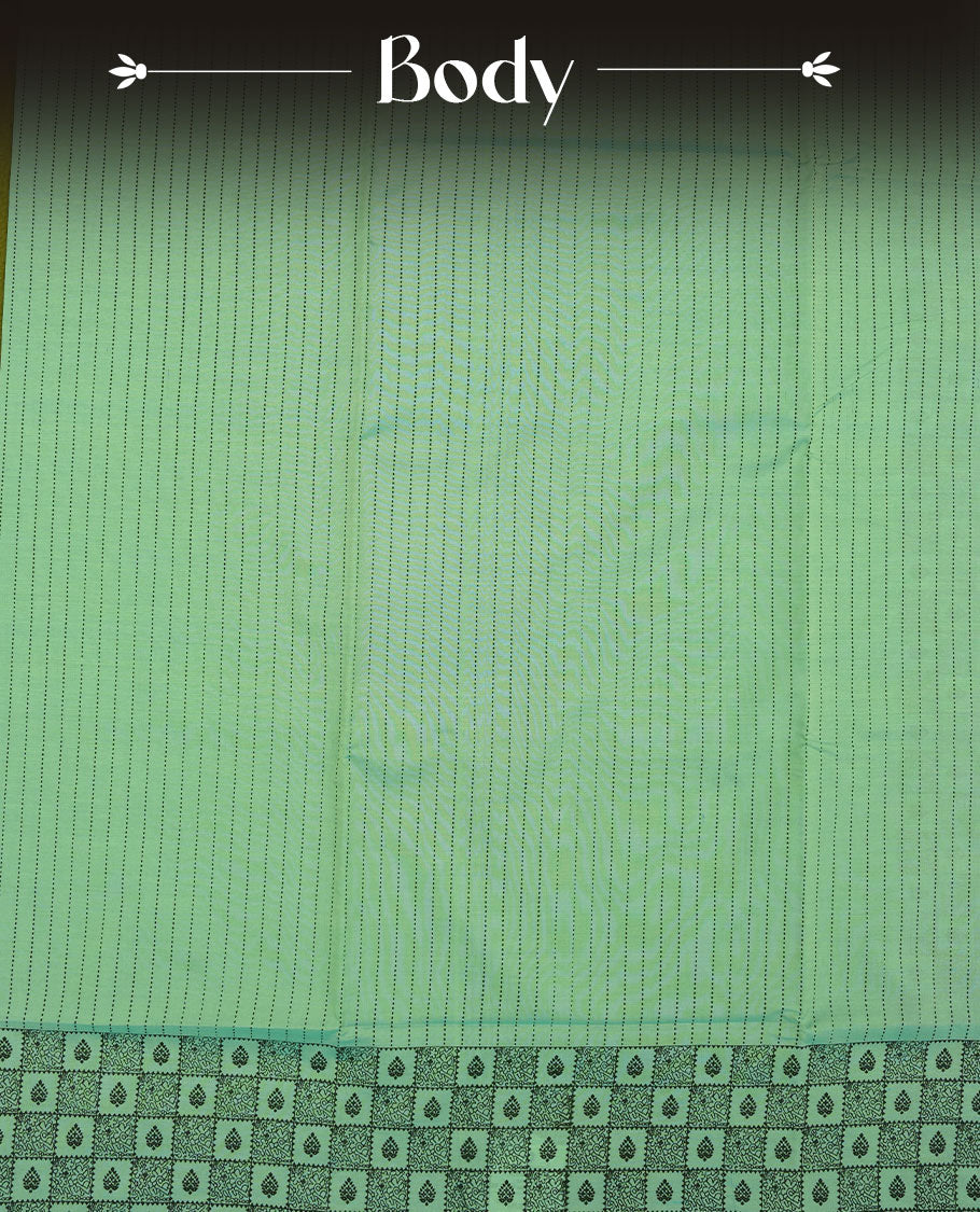 Pastel Green colour poly cotton saree with black vertical dotted line pattern on the body, paired with a matching pallu featuring black zigzag geometric border, and a coordinated all‑over black stylised fleur‑de‑lis printed blouse piece.