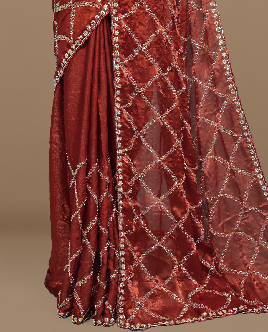 Brownish Orange colour designer saree featuring Sequins & cut beats worked body, cut beat worked border, paired with matching unstitched blouse.