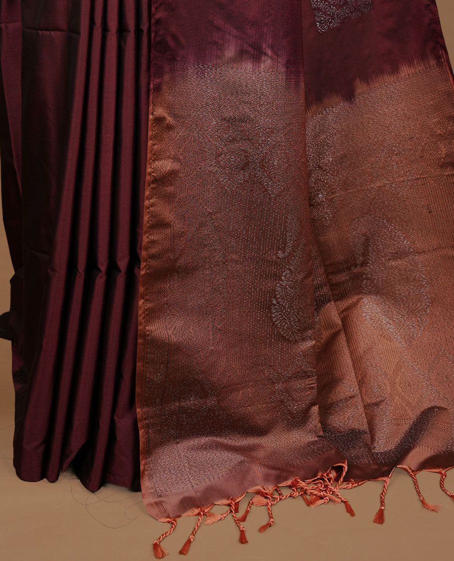 Maroon colour soft silk saree features a sleek borderless design with intricate antique zari motifs, flowing into a striking contrast biscuit orange pallu and a matching blouse piece.