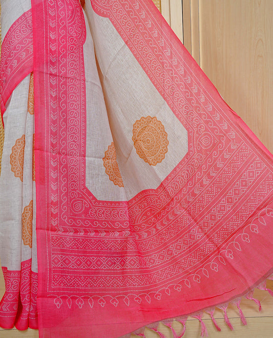 Cream colour semi linen saree featuring Mustard Ajrakh pattern print on body, complemented by contrast Light red colour with same pattern print border, comes with matching blouse piece.