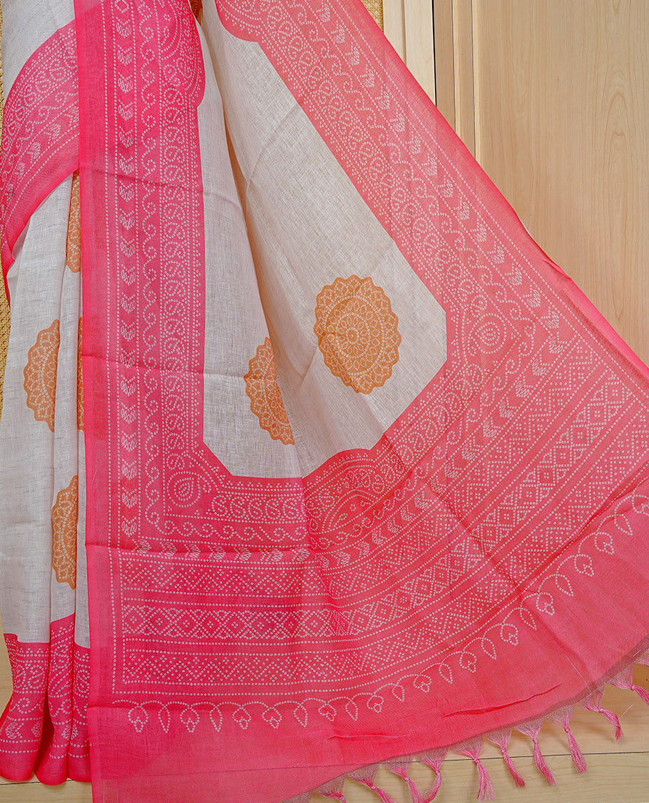 Cream colour semi linen saree featuring Mustard Ajrakh pattern print on body, complemented by contrast Light red colour with same pattern print border, comes with matching blouse piece.