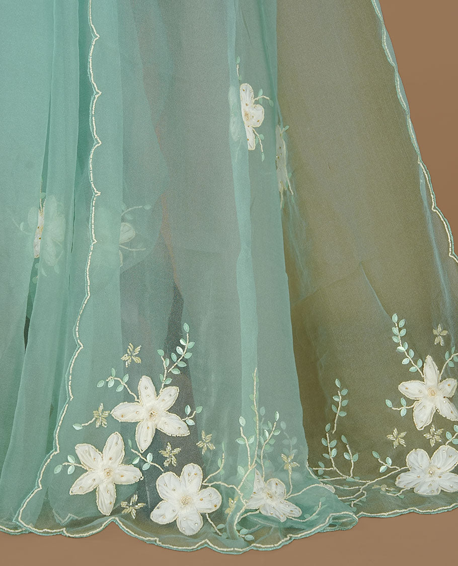 Aqua colour crush organza saree featuring white floral work with beats & sequins, highlighting scalp with beats worked border, paired with matching blouse piece.