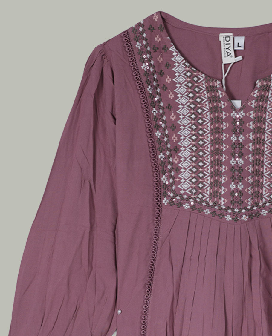 Mauve three-quarter sleeve tunic top with round neckline, intricately patterned embroidered yoke, front pleats, side lace inserts, and scalloped embroidered cuffs.
