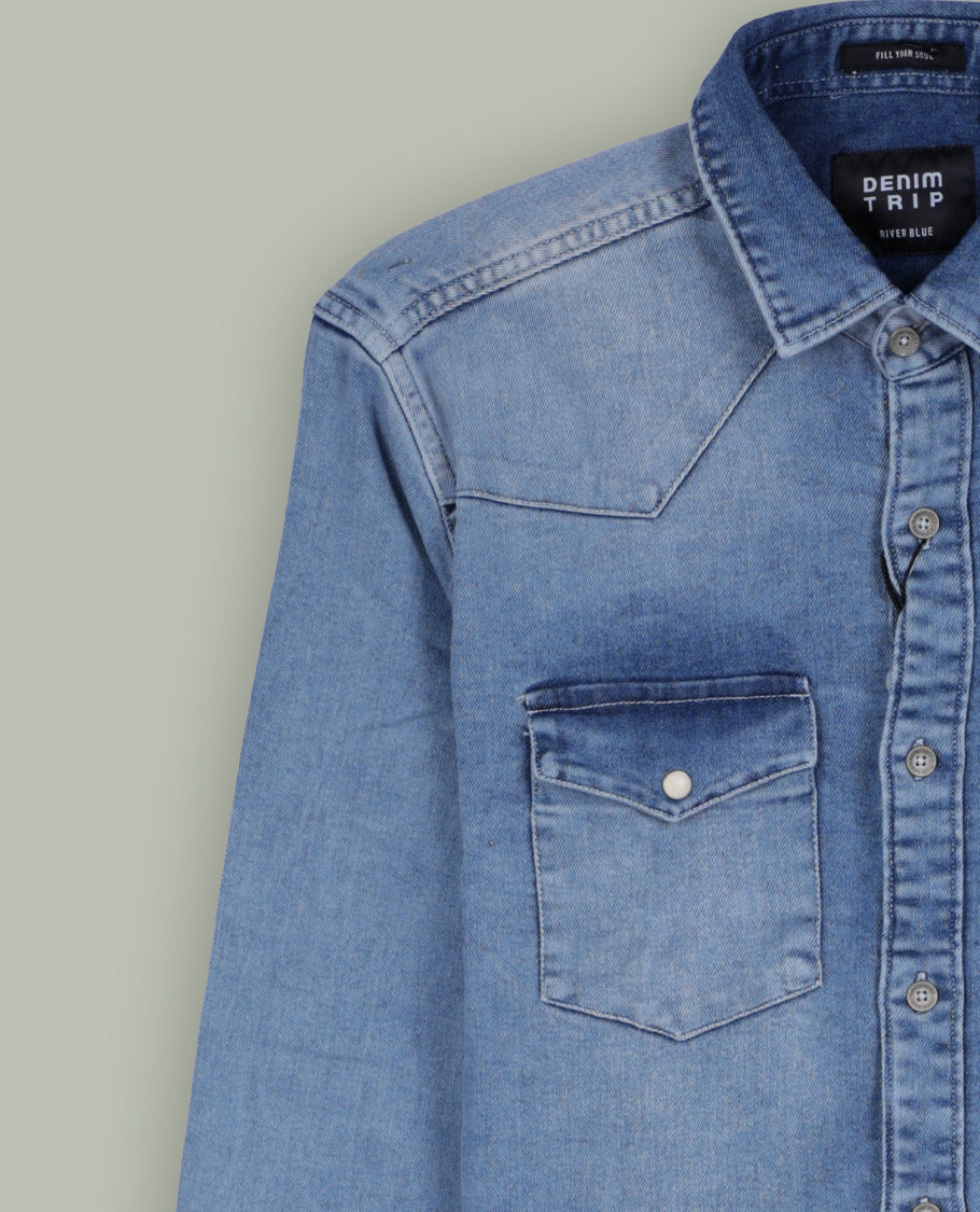 Light blue colour denim shirt with a faded wash finish, Features two front flap pockets, button down closure, and long sleeves with cuffs, Perfect for a rugged yet casual look.