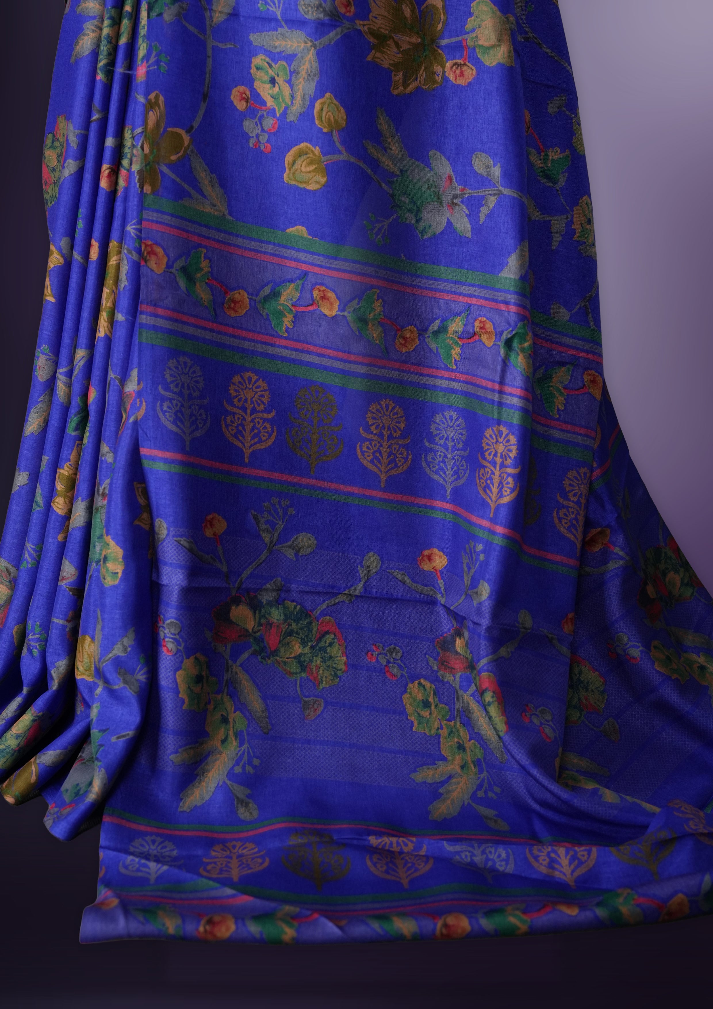 Violet blue colour saree enhanced with a vibrant blue colour floral prints on body & pallu, and  comes with a matching blouse.