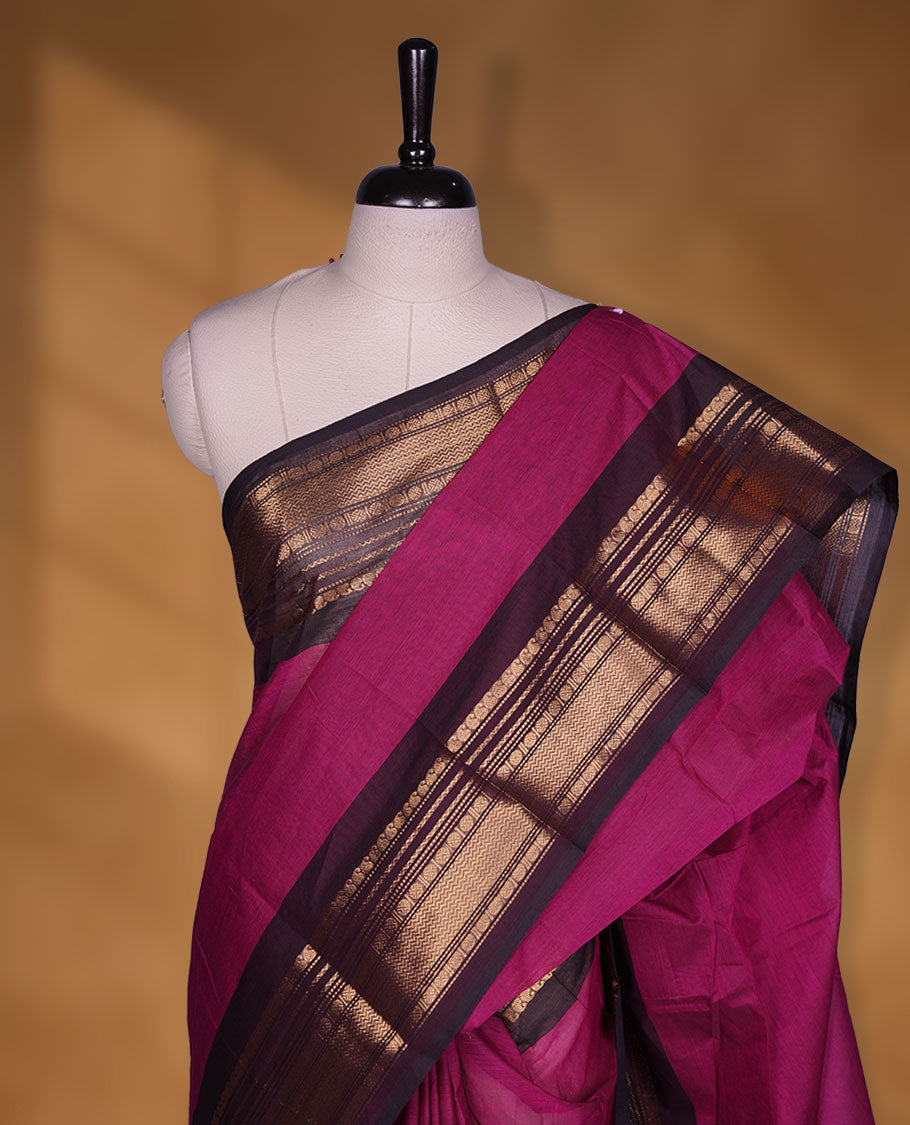 Dark Magenta colour chettinad cotton saree featuring plain body, contrast Dark brown colour with traditional gold zari border paired with matching blouse.
