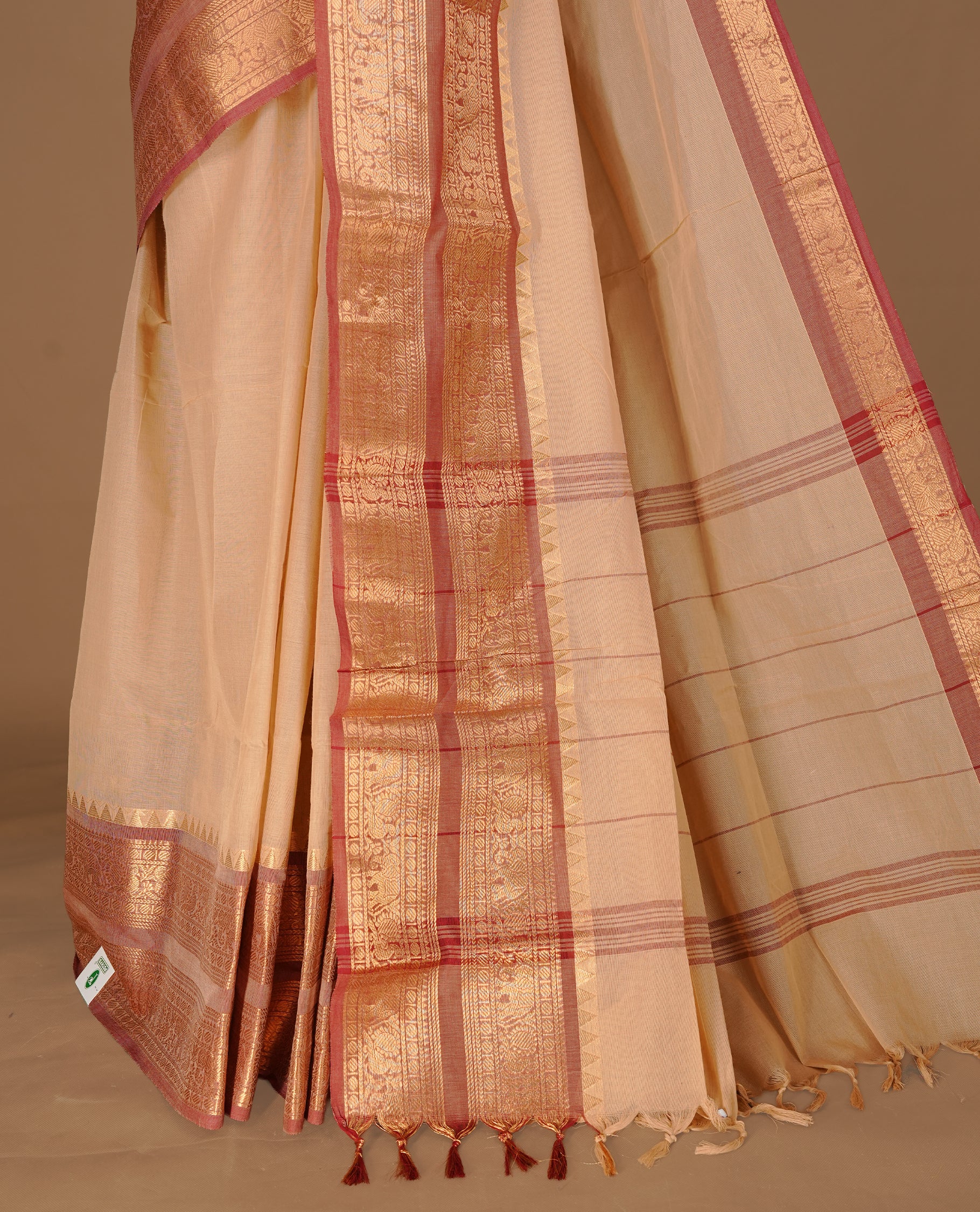 Sandalwood Colour chettinad cotton saree featuring Elegant plain body, complemented by contrast Brick red colour with gold zari border, paired with matching blouse.
