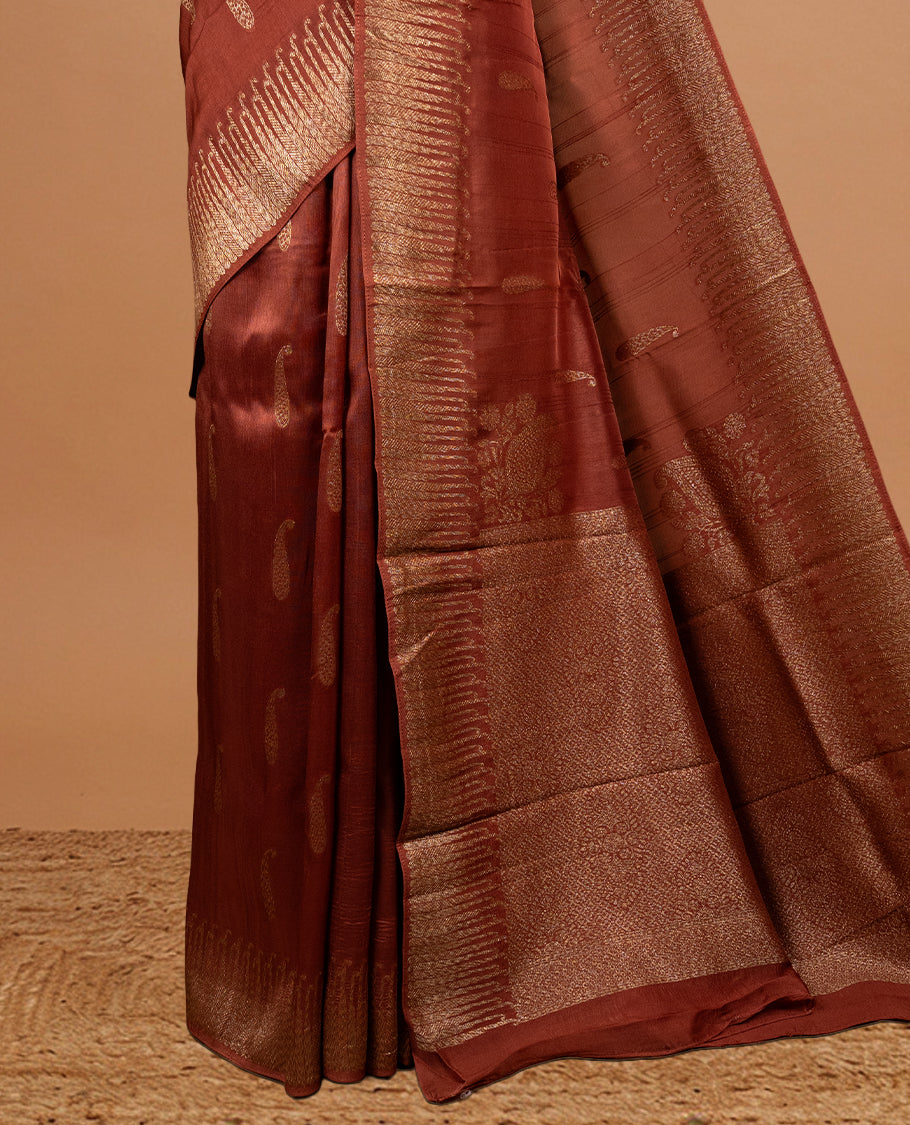 Brown colour Semi Banaras Tussar Georgette Featuring Gold zari Leaf pattern on body, Finished with Gold zari border and paired with matching blouse piece.