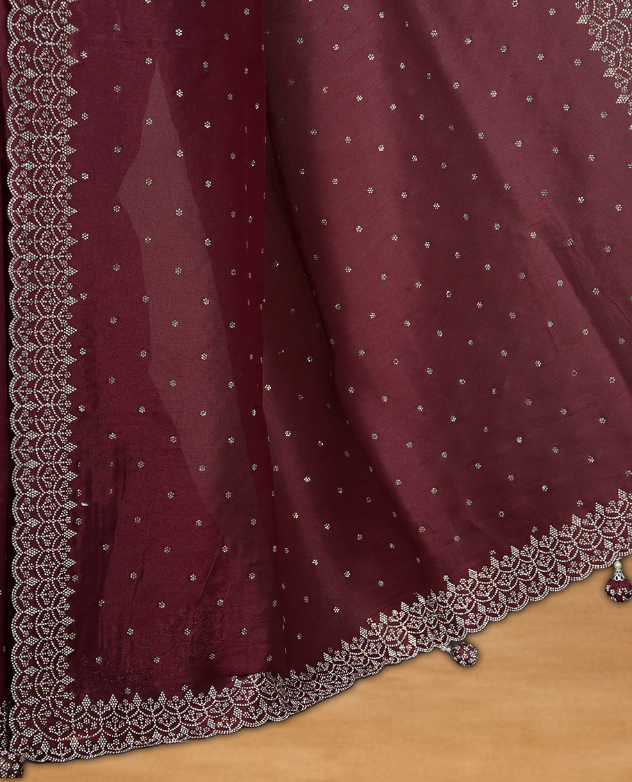 Maroon Colour Shimmer Designer Saree featuring Delicate White Stone Scattered Work on the Body, enhanced with Intricate Stone Detailing on the Border and Pallu, paired with a Matching Blouse.