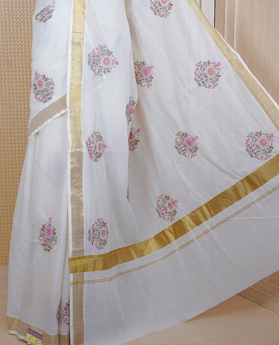 Cream colour cotton Kerala saree featuring Floral Thread work buttas body, complemented by gold kasavu Border, comes with matching blouse piece.