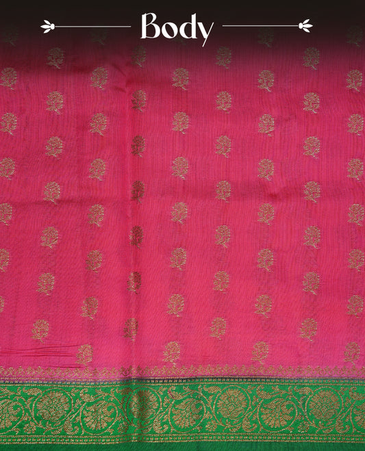 Magenta colour pure tussar Banaras silk saree featuring intricate gold zari motifs across the body, enhanced with a contrast green floral kodi zari border for a rich traditional look. Comes with a matching blouse piece.