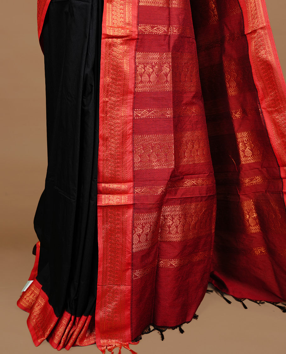 Black colour kalyani cotton saree featuring gold zari motifs on body, highlighting contrast Maroon colour with Antique gold zari border, paired with matching blouse piece.