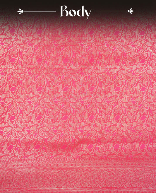 Rani Pink Colour Softie Silk Saree Featuring An All Over Gold Woven Leaf Pattern, Finished With A Matching Border Adorned With Intricate Paisley And Floral Motifs, Paired With A Matching Blouse Piece.
