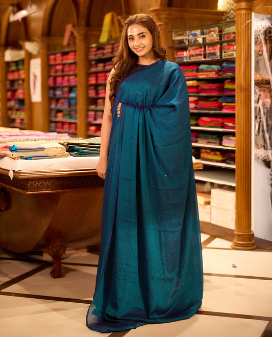 Teal Blue colour viscose saree in rich teal shade featuring a subtle sheen and lightweight drape, enhanced with satin piping finished border, paired with a matching blouse piece