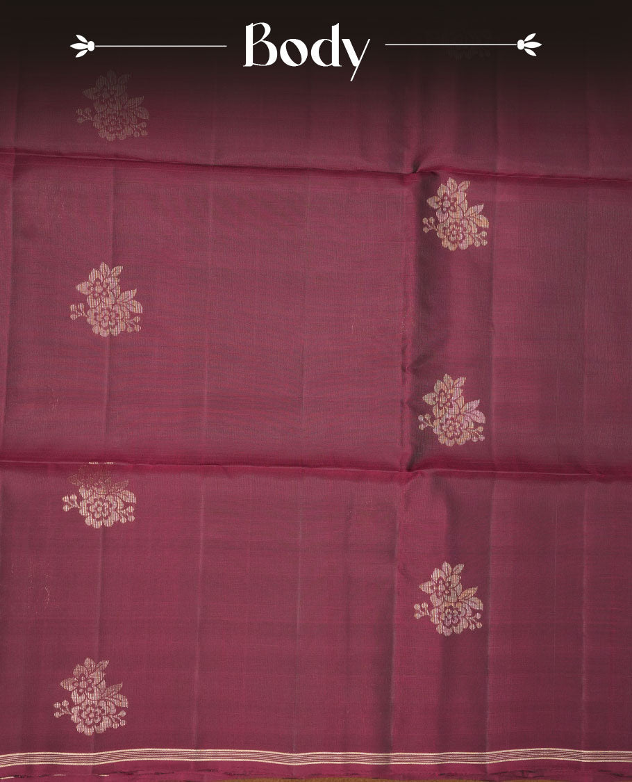 Burgundy colour soft silk saree featuring gold zari motifs on body, complemented by self colour with traditional border with tassel at pallu, paired with matching blouse piece.