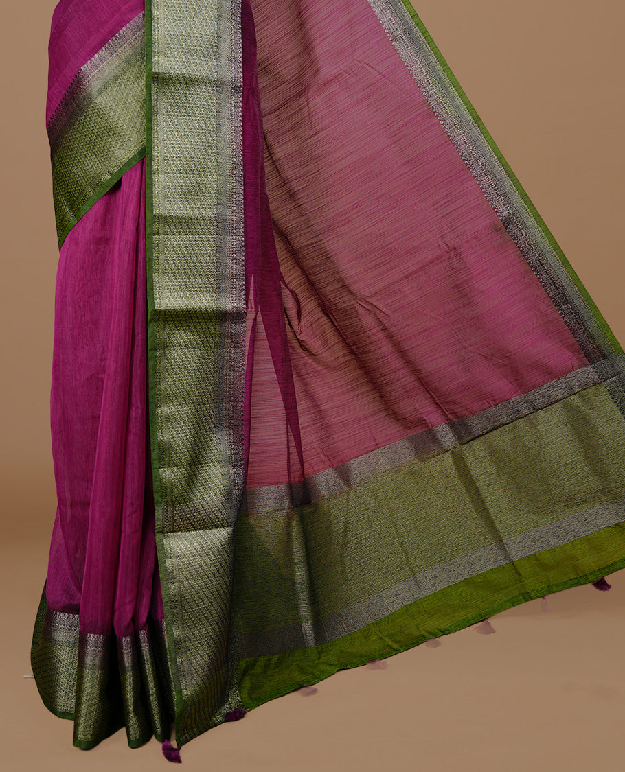 Burgundy colour Semi linen saree featuring Elegant plain body, complemented by contrast Green colour With Antique zari border, paired with matching blouse piece.