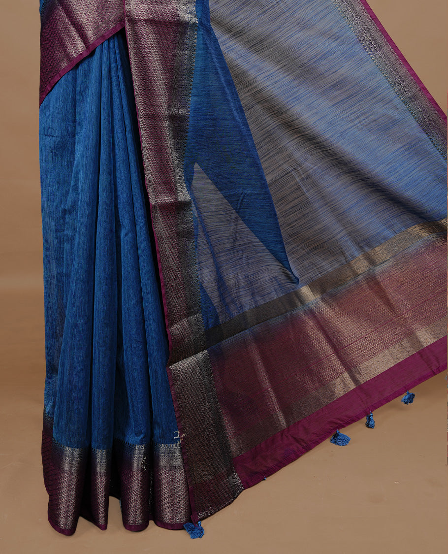 Teal colour Semi linen saree featuring Elegant plain body, complemented by contrast Maroon colour With Antique zari border, paired with matching blouse piece.
