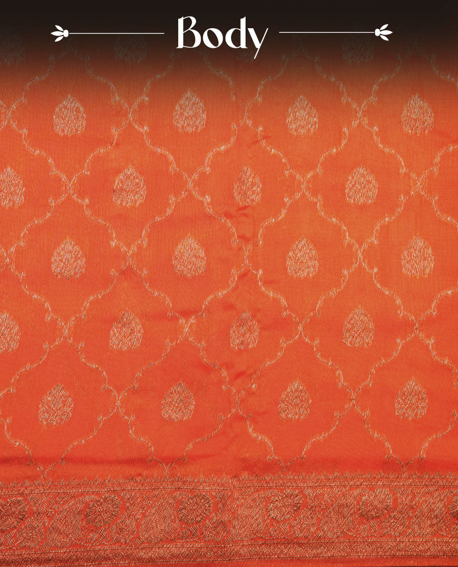 Orange semi Banaras saree with gold zari buta motifs, finished with a traditional gold zari border and pallu, paired with a matching blouse.