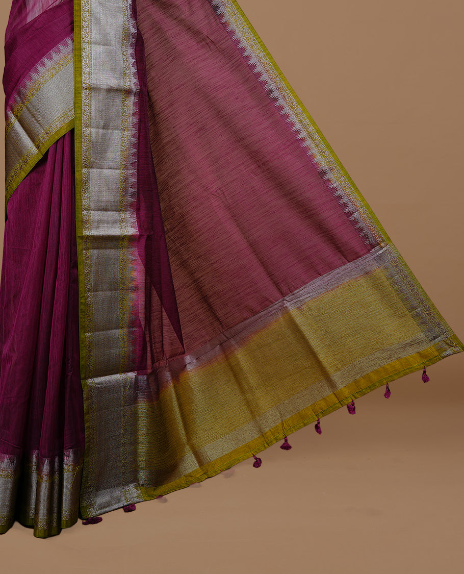 Grape colour Semi linen saree featuring Elegant plain body, complemented by contrast Green colour With Antique zari border, paired with matching blouse piece.