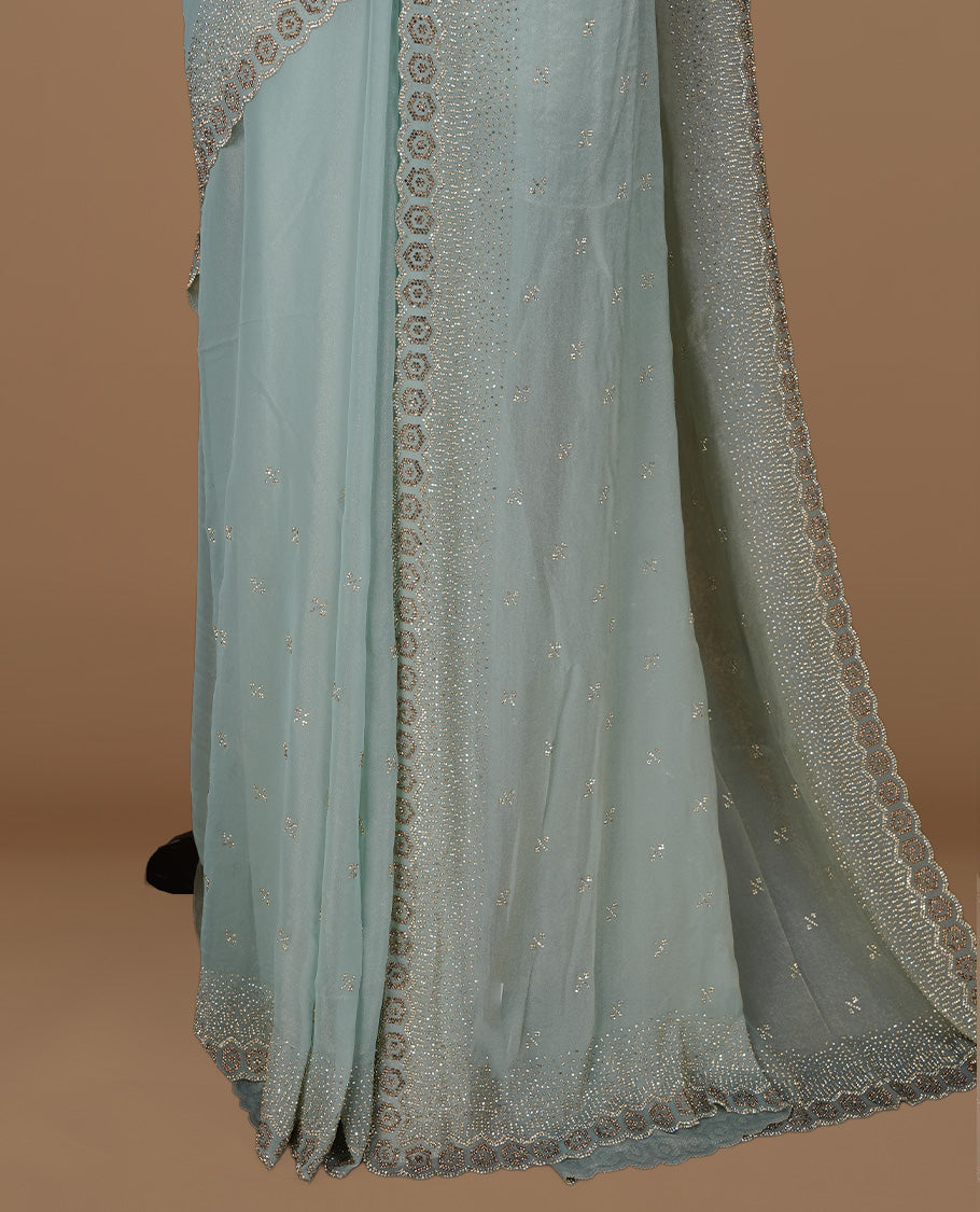 Mint colour designer saree featuring gold & white stone worked body and border, paired with matching blouse piece.