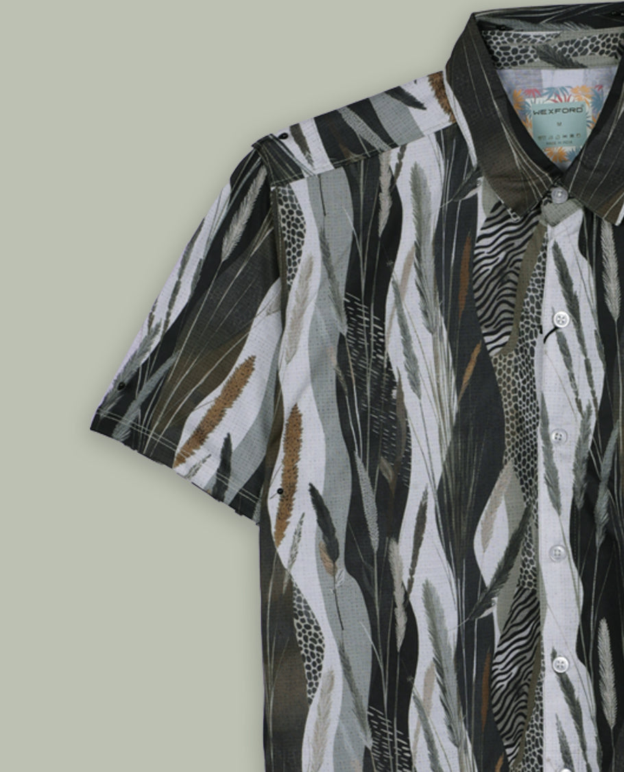 Green, black, and white shirt features a classic spread collar and short sleeves, Its bold feather like print and lightweight fabric make it perfect for casual wear or tropical getaways.