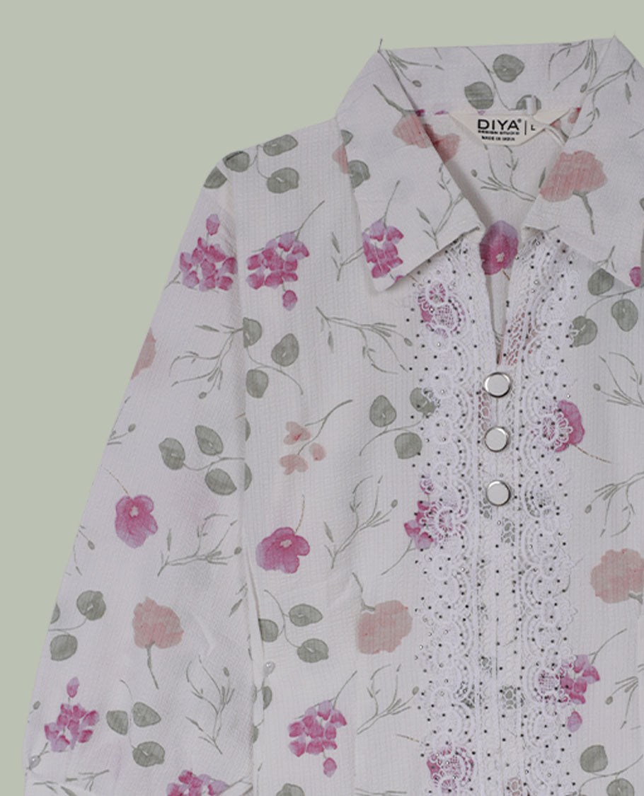 White floral printed shirt top with collared neckline, three-quarter sleeves, and front button placket framed by embroidered lace detailing.