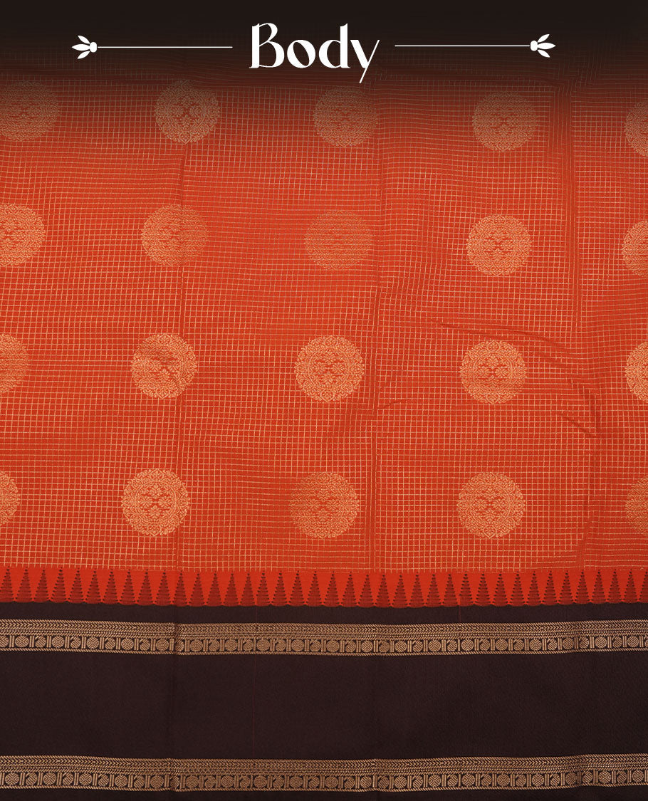 Dark Rust orange colour semi silk saree featuring gold zari checks with floral motifs on body highlighting contrast dark chocolate gold zari small mango border , paired with matching blouse